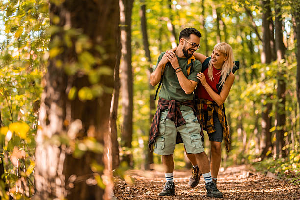 istock Happy couple walking together in a forest. 2237848474
