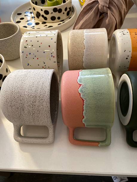 istock Colorful ceramic mugs in various designs displayed on a shelf, ideal for home decor enthusiasts 2237848529