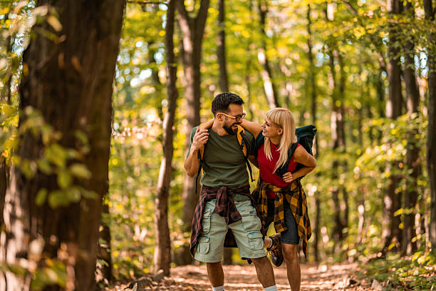 istock Happy couple walking together in a forest. 2237848675