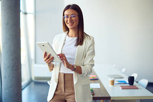 istock Young businesswoman using digital tablet smiling in modern office 2237854624