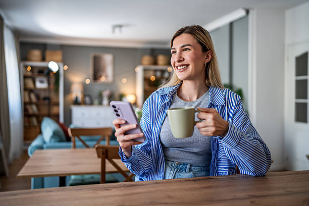 istock Woman relaxing at home, drinking coffee and using phone 2237858387