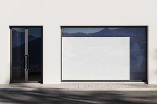 istock Realistic storefront with large window poster mockup on clean white wall background with glass door and outdoor sidewalk scene in daylight. 3D Rendering 2237860521