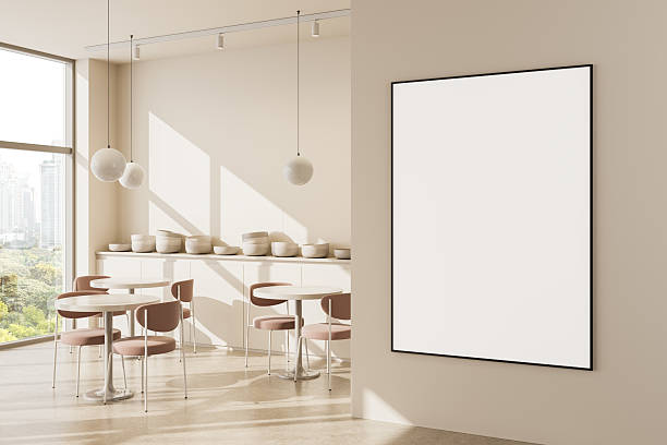 istock Modern cafe interior with large vertical poster mockup on beige wall and sunlight casting shadows from window and pendant lights. 3D Rendering 2237860657
