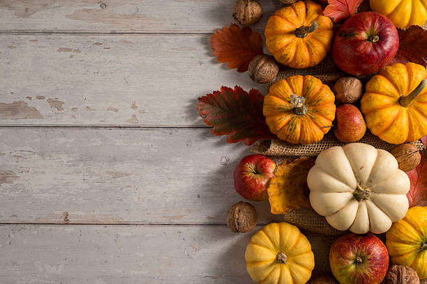 istock Autumn pumpkins background. Orange and white mini squashes in a basket. 2237865931