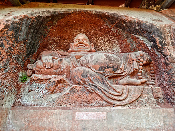 Big Buddha statue at the Oriental Buddha Capital (Dongfang Fodu) in Leshan, China, known for its intricate rock carvings of numerous Buddha statues, bodhisattvas, and arhats. It is considered the fifth-largest Grotto group in China and a significant attraction alongside the famous Leshan Giant Buddha.