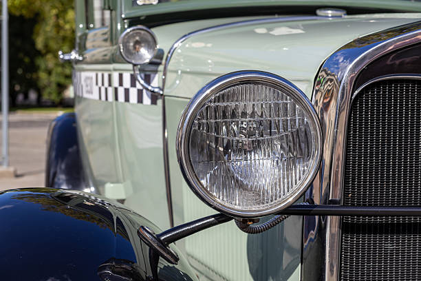istock Detailed close-up captures a bright vintage car headlight, its gleaming chrome bezel, distinctive dark grille, and classic checkerboard side panel, embodying automotive history 2237872525
