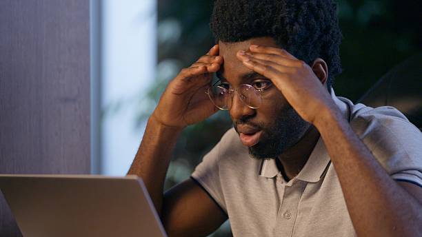 istock Stressed businessman African American business man in office deadline difficult job problem laptop working online trouble mistake failure upset computer overtime night working sad overworked employee 2237874940