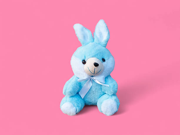 istock Adorable Blue Stuffed Bunny on the Pink Background 2237880306