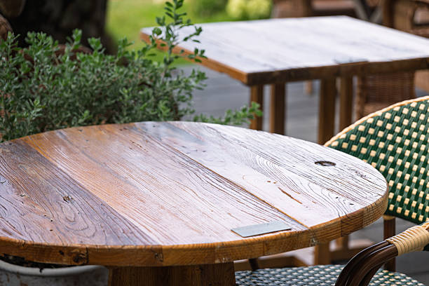 istock A Rustic Wooden Round Table Surrounded by Greenery in a Serene Outdoor Garden Setting 2237880466