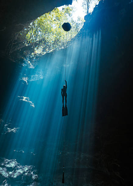 istock a freediver ascends in a beautiful cenote 2237881885