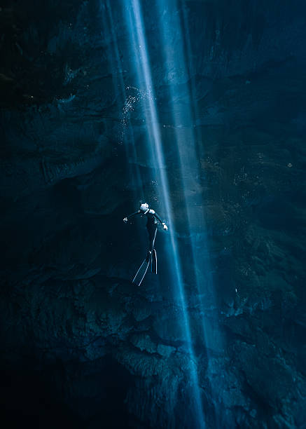 istock A freediver gliding in a Cenote sunbeam 2237881892