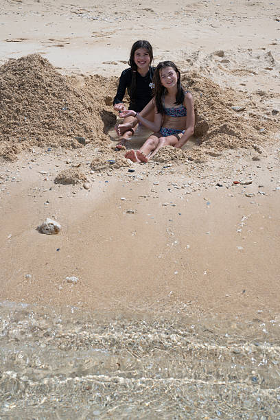 Young girls play on sandy beach, Onna, Okinawa