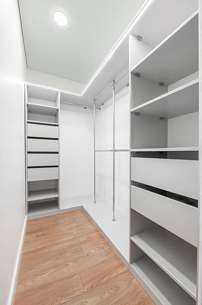 istock Modern White Walk-In Closet With Open Shelving and Wooden Flooring. Storage Room 2237891712