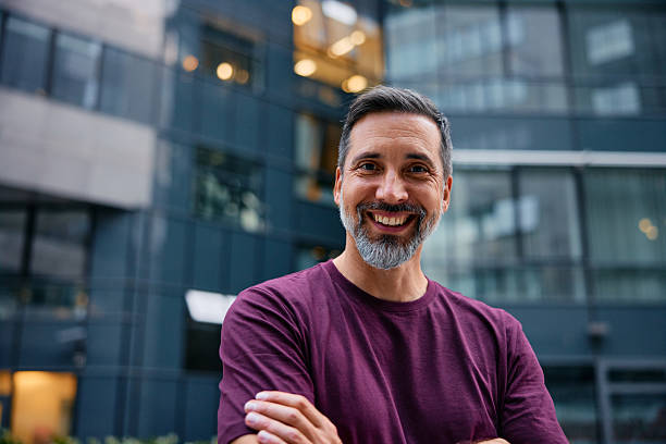 istock Smiling mid adult man standing outside office building 2237894534