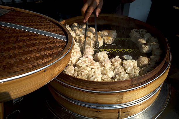 istock Hand pickups Chinese dim sum in bamboo steamers 2237896629