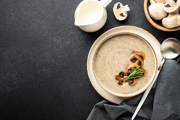 istock Mushroom soup puree in craft bowl on black background. Top view with space for text. 2237897664