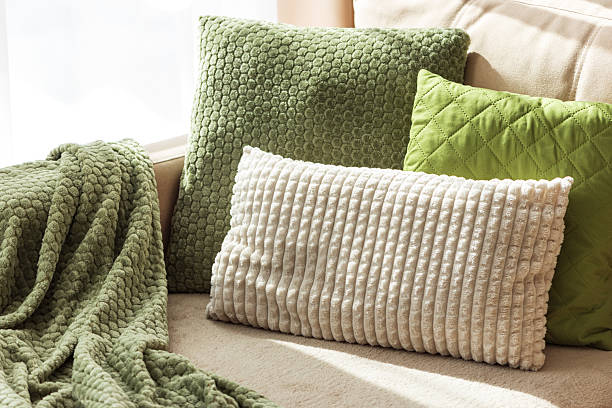 istock Textured Pillows and Blanket on Cozy Beige Sofa 2237899282