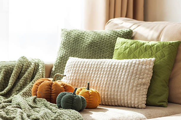istock Cozy Autumn Sofa with Fabric Pumpkins and Textured Pillows 2237899288