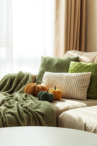 istock Cozy Autumn Sofa with Fabric Pumpkins and Textured Pillows 2237899289