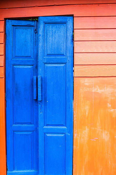 Blue wooden door with orange wall