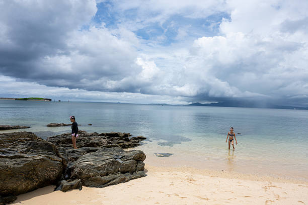 istock Sisters explore rocky shoreline and shallows 2237903610