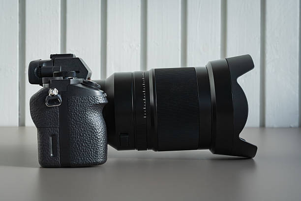 istock Modern black mirrorless camera with a professional telephoto lens on a table, representing photography and videography equipment. 2237903745