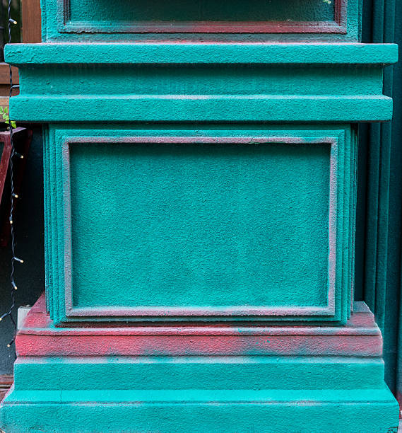Vibrant green teal wall with textured surface and contrasting red accents, showcasing architectural details and artistic expression, creative design and visual storytelling, background with copy space