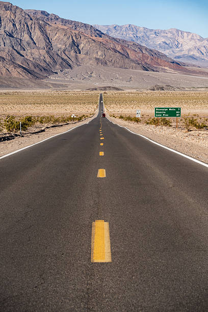 Highway through Mesquite Flat Sand Dunes in Death Valley National Park in California.