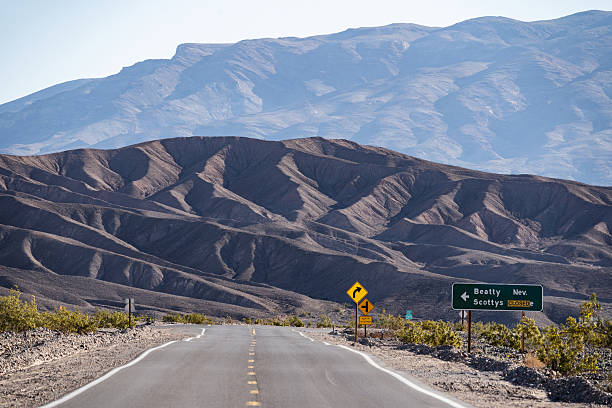 Highway through Mesquite Flat Sand Dunes in Death Valley National Park in California.