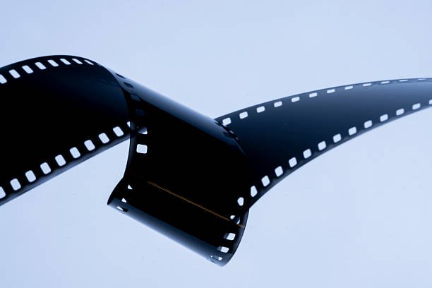istock Film strip template with three blank or empty frames, developed 135 type or 35mm film placeholder on white, real film grain 2237909531