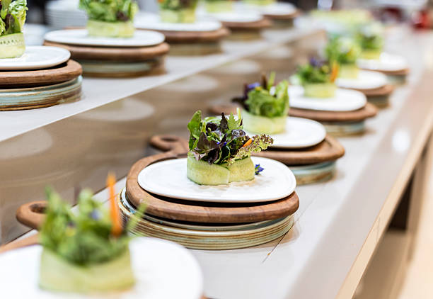 Gourmet salad plates in line at luxury restaurant kitchen
