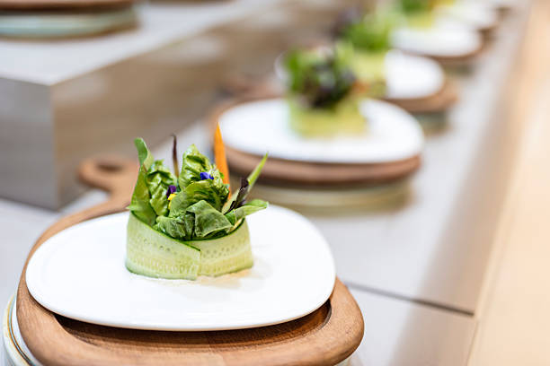Gourmet salad plates in line at luxury restaurant kitchen