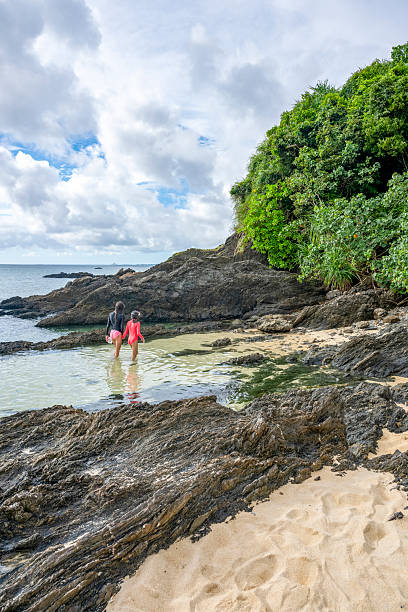 Young girls explore sea shallows, Onna , Okinawa