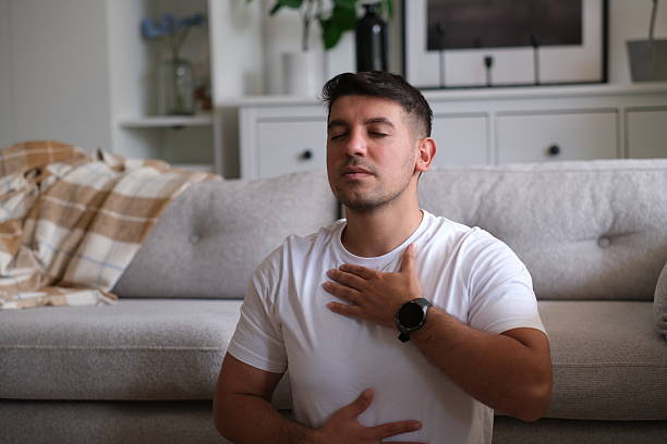 istock Man doing calming breathing exercises at home 2237910980