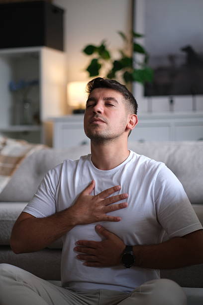istock Young man meditating at home 2237912060