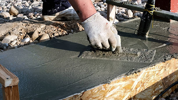 istock A construction worker smooths wet concrete with trowel in formwork on a building site. Smoothing to create a flat surface. Professional hand work with foundation. High quality photo 2237913455