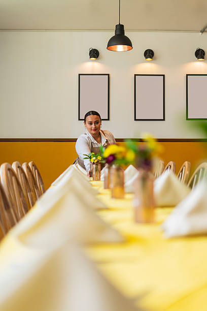 The Latina owner of a restaurant in Bogota, Colombia, prepares to open the doors and begin serving customers.