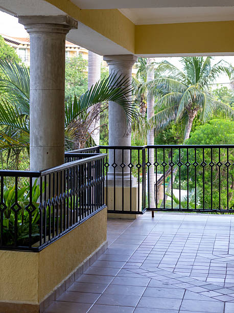 Railing pattern overlooking a golf course and lake - shallow depth