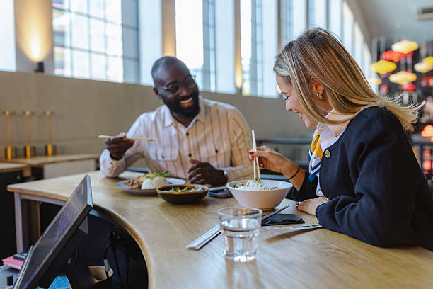 istock Two coworkers enjoy a friendly business lunch at a bright modern restaurant 2237919256