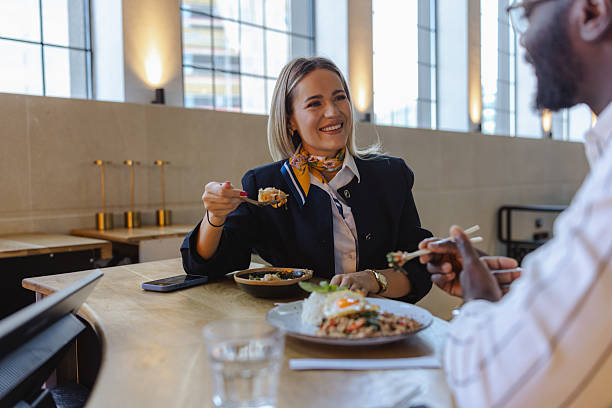istock Two professionals share a lively business lunch at a modern restaurant, enjoying conversation and good food 2237919373