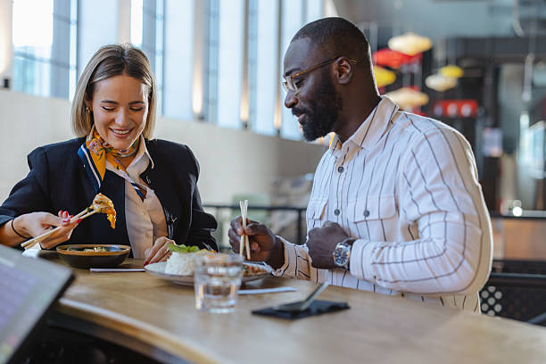 istock Two coworkers share a cheerful business lunch 2237919671