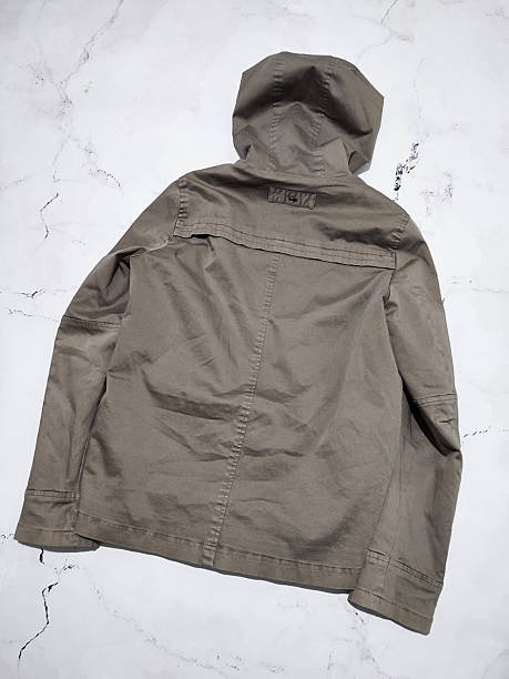 istock Fade olive green hooded parka jacket flat lay top view isolated on white marble background. Short winter khaki cotton parka with insulation. Military style casual women's coat. Army green outerwear 2237923861