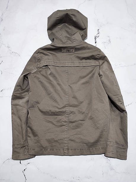 istock Fade olive green hooded parka jacket flat lay top view isolated on white marble background. Short winter khaki cotton parka with insulation. Military style casual women's coat. Army green outerwear 2237923875