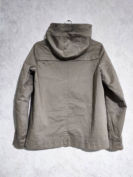 istock Fade olive green hooded parka jacket hangs on hanger isolated on white marble background. Short winter khaki cotton parka with insulation. Military style casual women's coat. Army green outerwear 2237923878