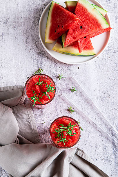 istock Refreshing watermelon rosemary detox drink in glasses on table top and vertical view 2237924717