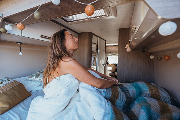 istock Woman Relaxing in Cozy Camper Bed Morning 2237926520