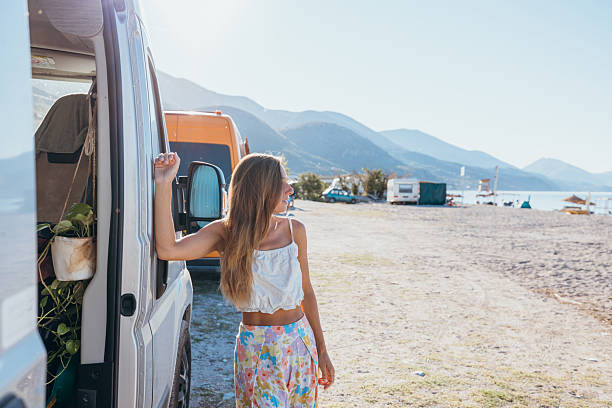 istock Woman Relaxing by Camper Van at Beachside 2237926925