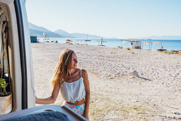 istock Woman Enjoying Beach View from Camper Van 2237928275