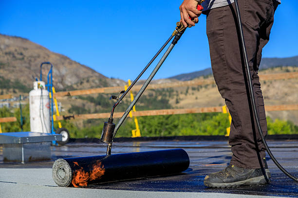 istock Roofer applying torch to bitumen membrane on torch down roof 2237928398