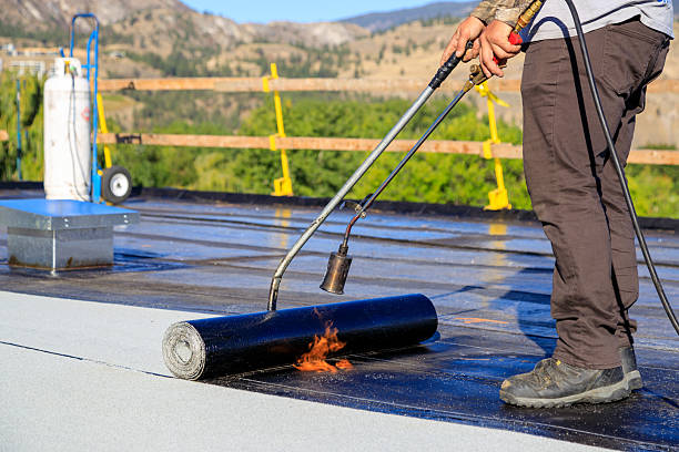 istock Roofer applying torch to bitumen membrane on torch down roof 2237928400